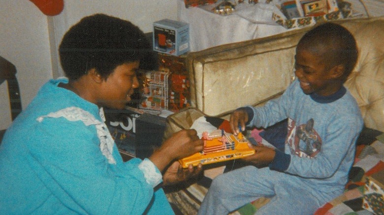 Nancy Hart and Kevin Hart playing with a toy