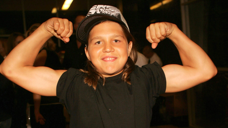 Young Richard Sandrak flexing his muscles