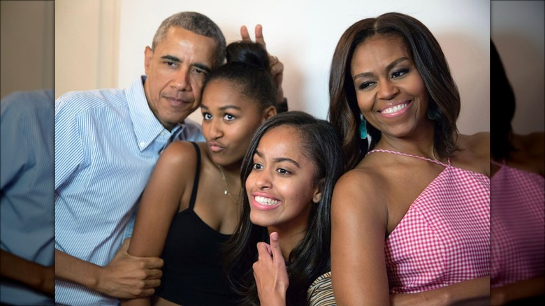 Barack, Sasha, Malia, and Michelle Obama taking a silly photo