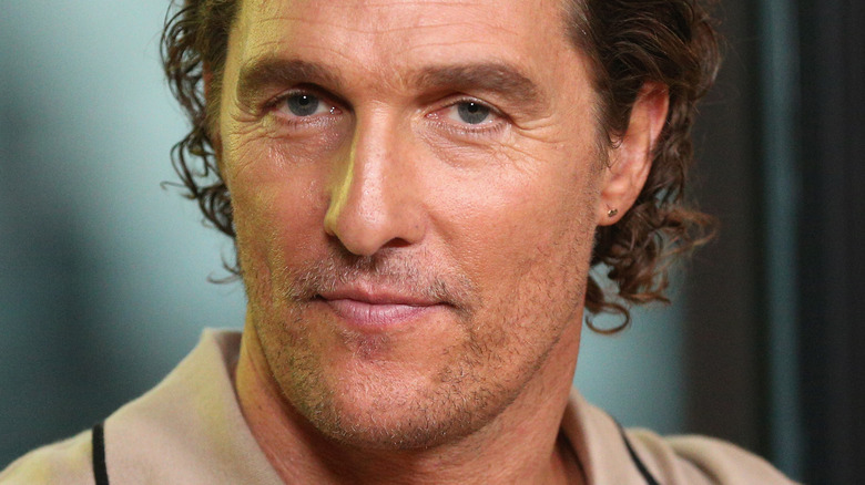 Matthew McConaughey poses in beige shirt