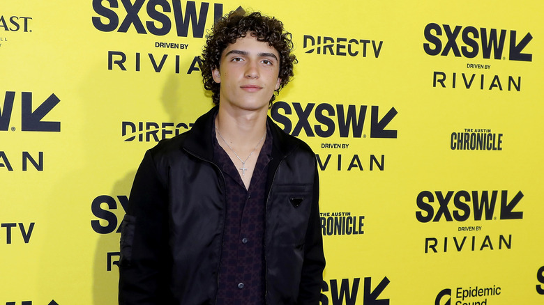 Levi McConaughey posing yellow background