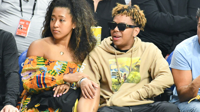 Naomi Osaka watching sports with Cordae