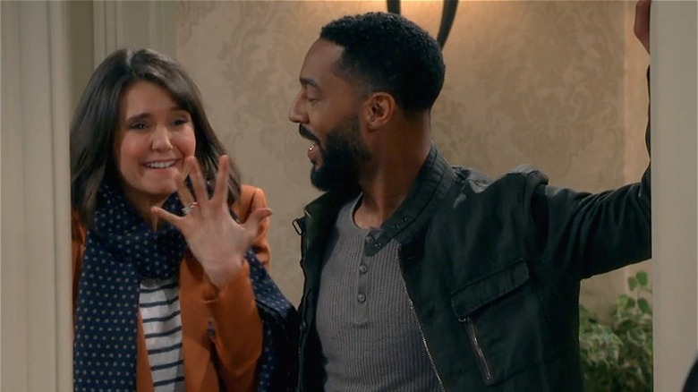 Nina Dobrev next to Tone Bell, showing off ring