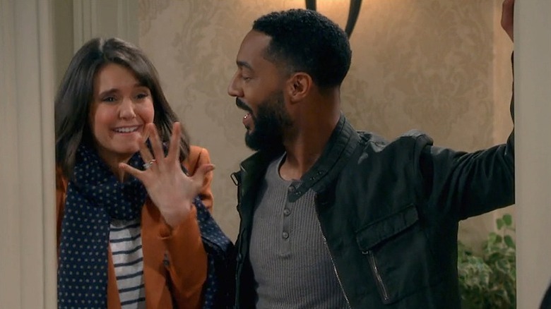 Nina Dobrev next to Tone Bell, showing off ring