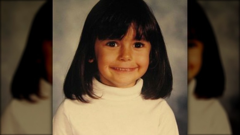 Nina Dobrev as a child, smiling