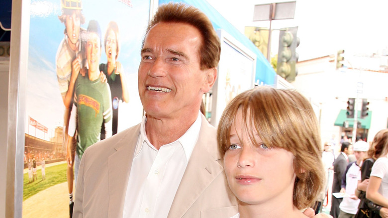 Arnold Schwarzenneger and son Patrick Schwarzenegger walking and smiling at premiere of The Benchwarmers