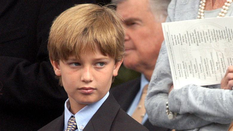 Patrick Schwarzenegger standing at the gubernatorial inuaguration of father Arnold Schwarzenegger