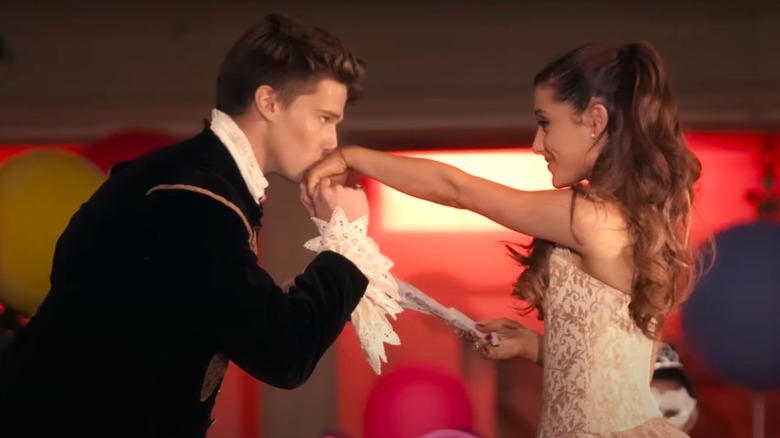 Patrick Schwarzenegger kissing Ariana Grande's hand in music video