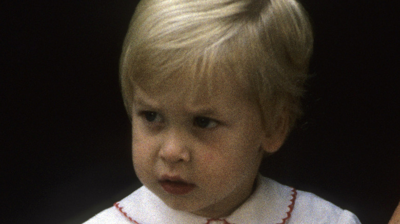 A young Prince William playing outside