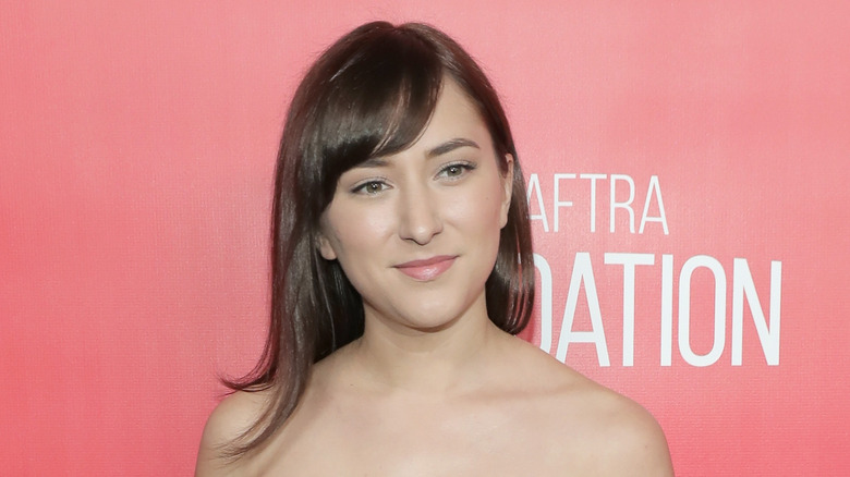 Zelda Williams posing in front of a pink background