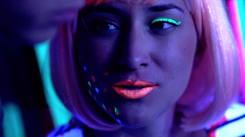 Zelda Williams with bright, glow-in-the-dark makeup in a scene from Teen Wolf