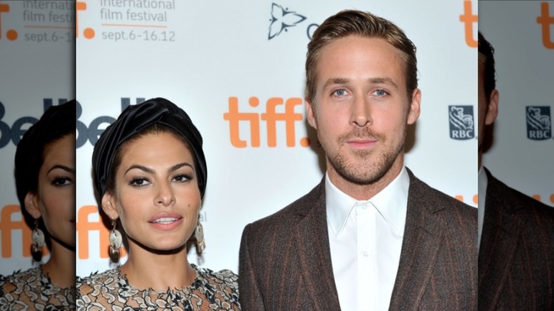 Eva Mendes and Ryan Gosling posing side by side.