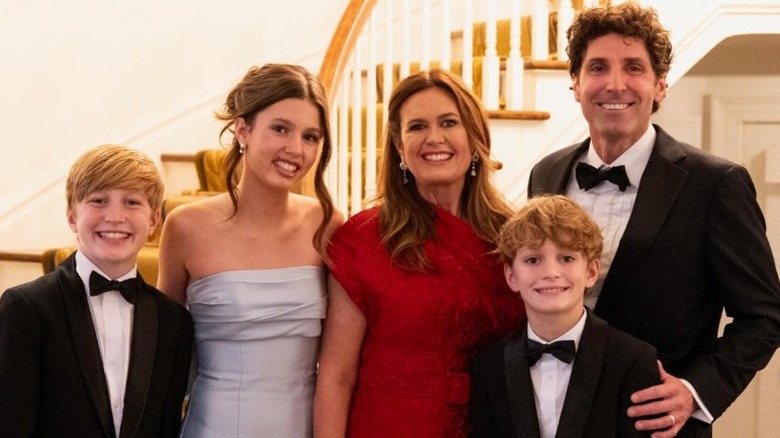 Sarah Huckabee Sanders posing with her husband and three kids on the beach