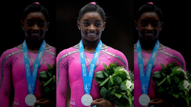 Simone Biles wearing medal