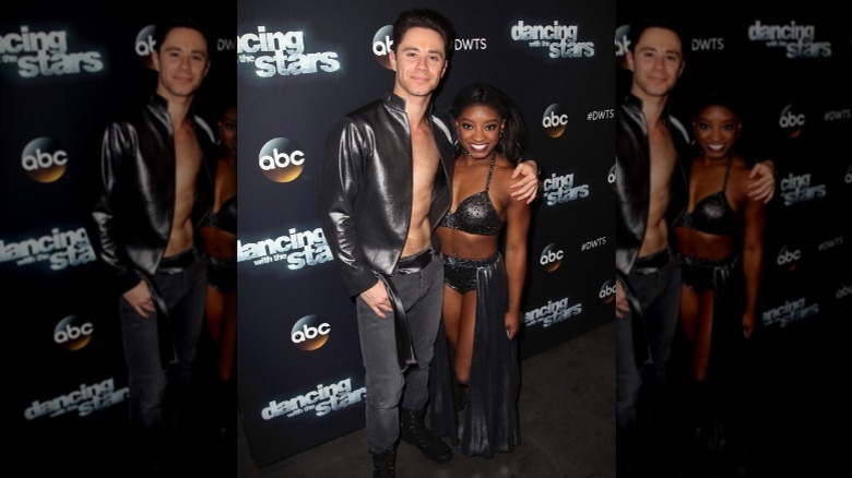 Sasha Farber with arm around Simone Biles
