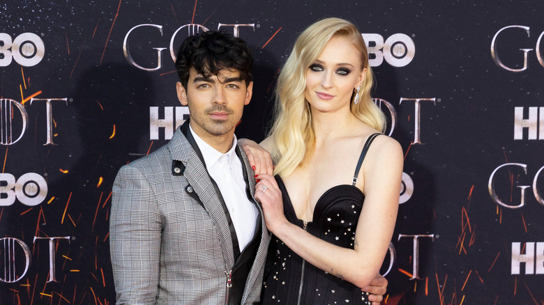 Sophie Turner with hands on Joe Jonas' shoulder