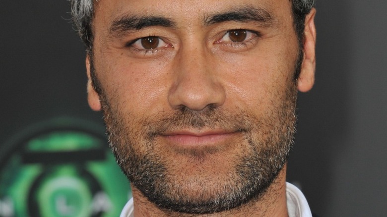 Taika Waititi half smiling