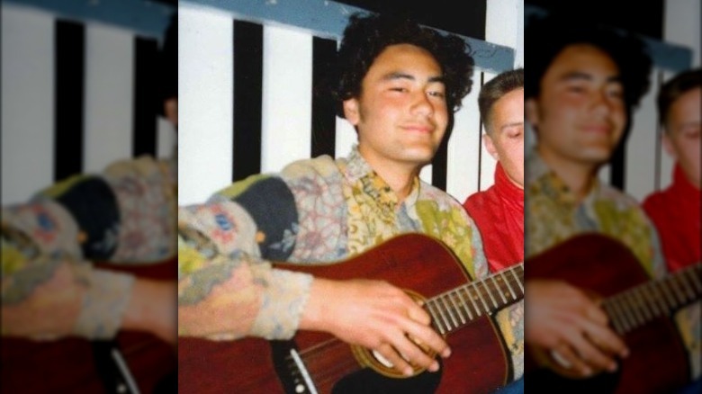 Young Taika Waititi with guitar