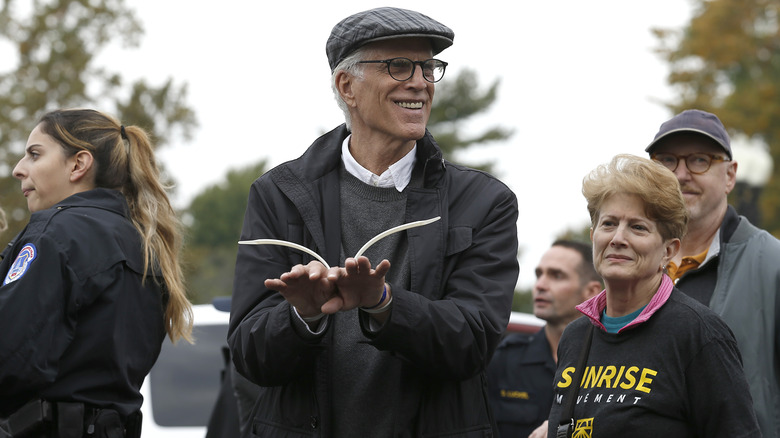 Ted Danson smiling while getting arrested