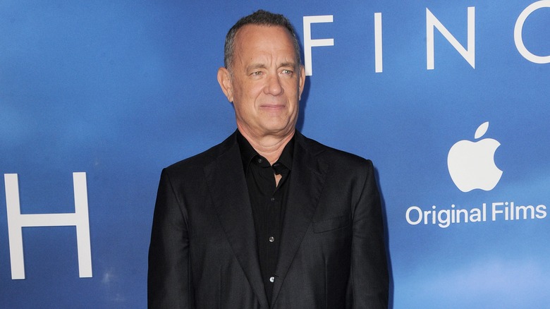 Tom Hanks wearing a black suit on the red carpet