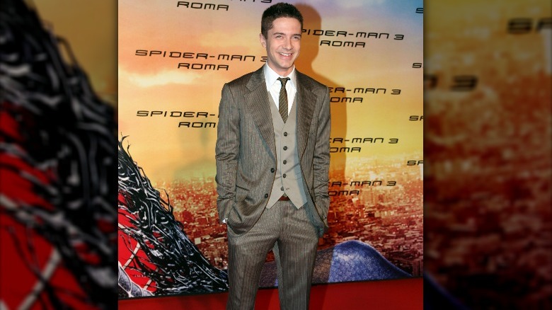 Topher Grace wearing gray suit