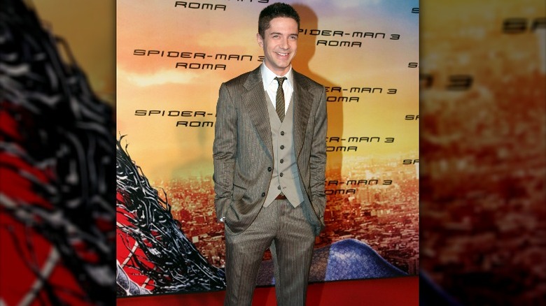 Topher Grace wearing gray suit