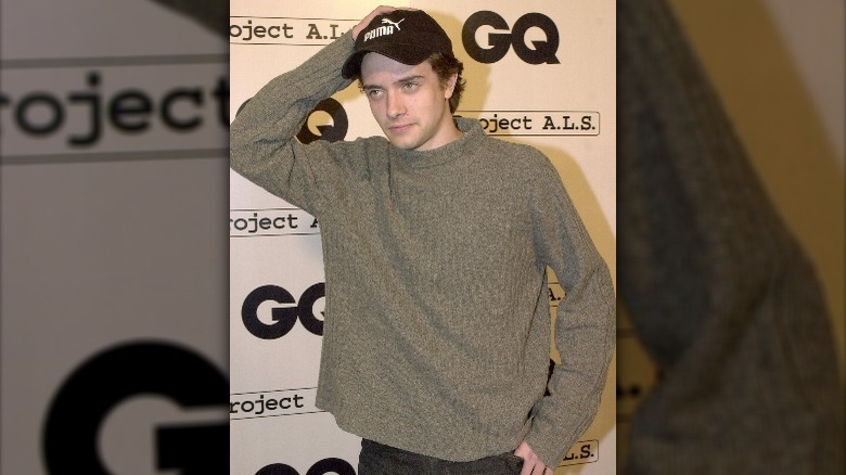 Topher Grace wearing gray sweater