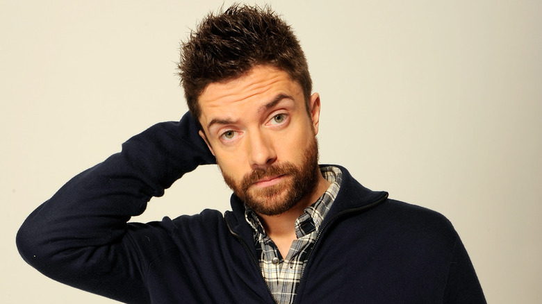 Topher Grace with hand behind head