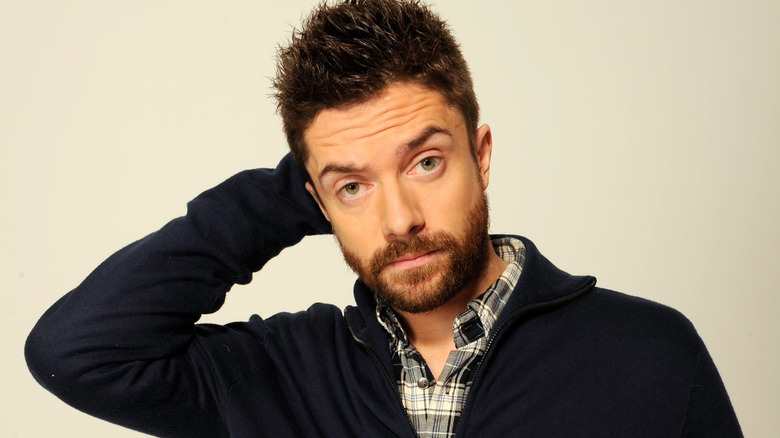 Topher Grace with hand behind head