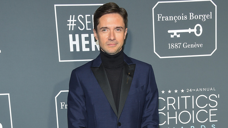 Topher Grace wearing black turtleneck