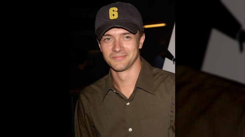 Topher Grace wearing baseball cap