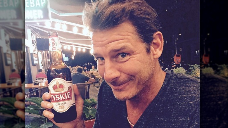 Ty Pennington holds a beer