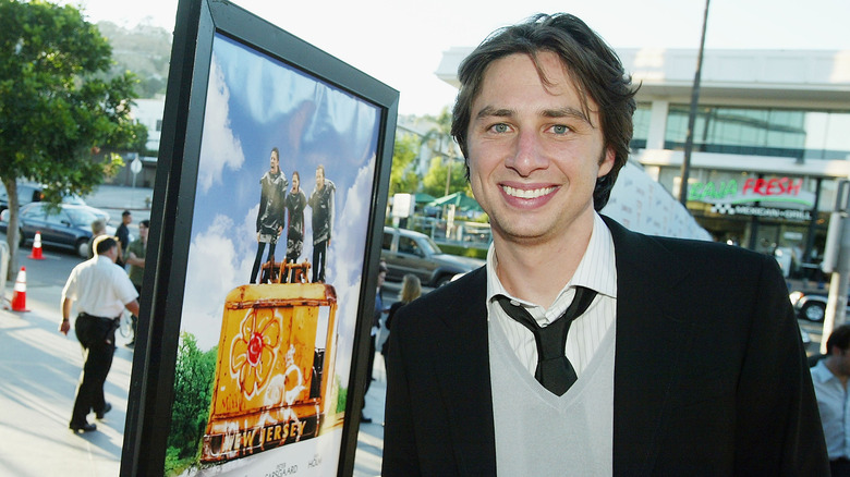 Zach Braff, promoting "Garden State" in 2004, smiling, next to movie poster