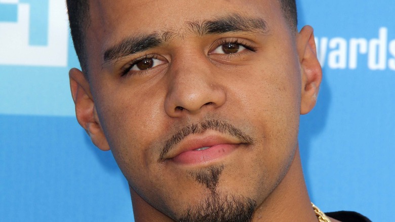 J. Cole gives a slight smile on the red carpet