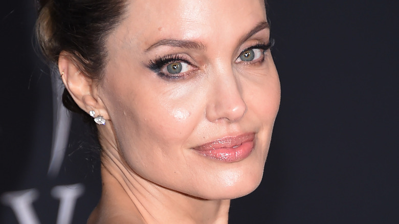 Angelina Jolie smiling on red carpet at Maleficent premiere