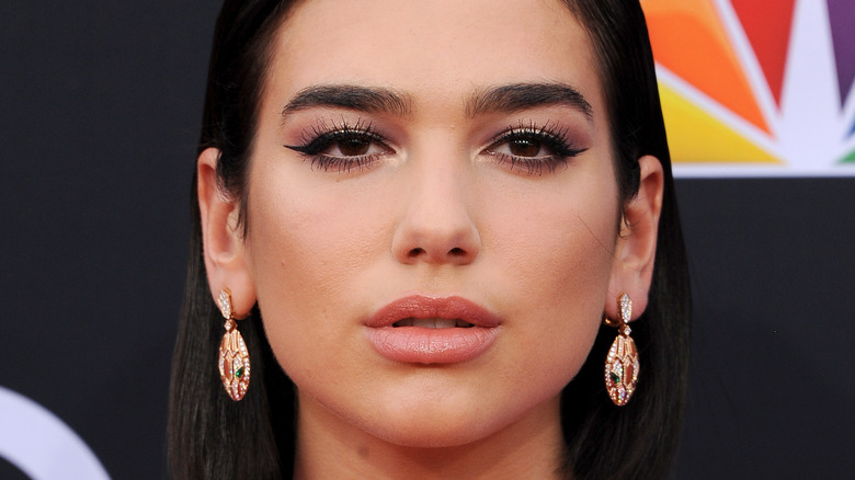 Dua Lipa with slightly pursed lips