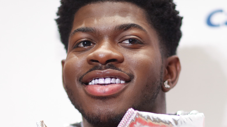 Lil Nas X wearing earrings