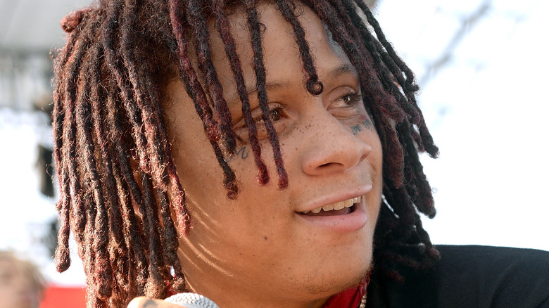 Trippie Redd smiling holding microphone