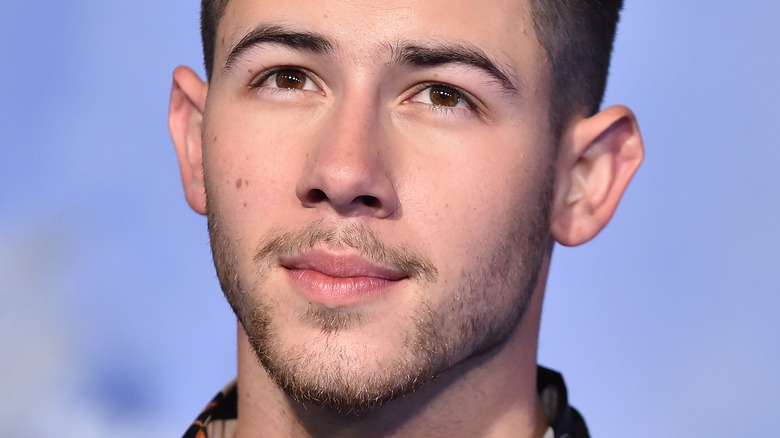 Nick Jonas slightly smiling