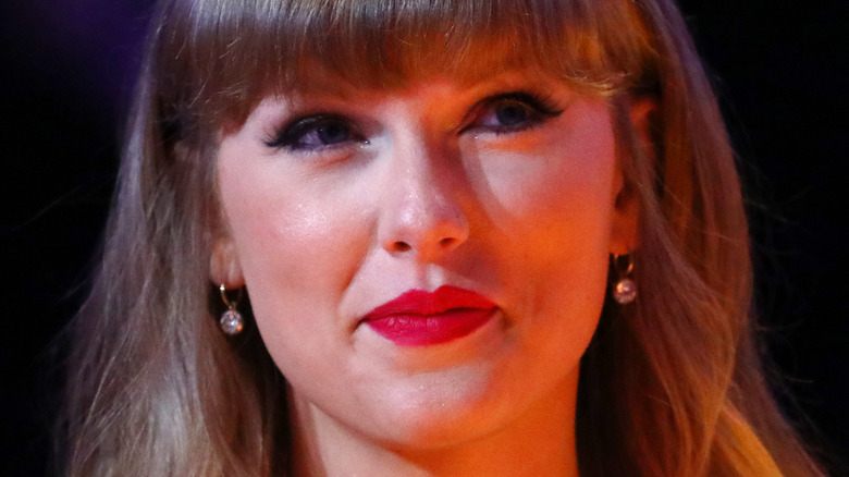 Taylor Swift subtly smiles at the camera