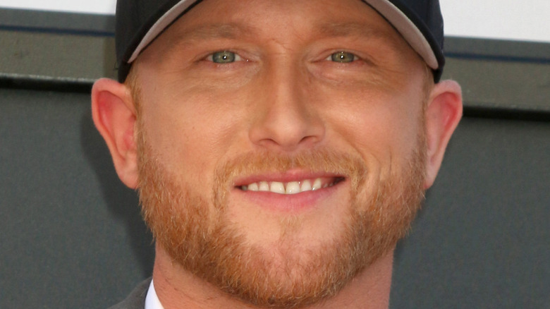 Cole Swindell posing in baseball cap