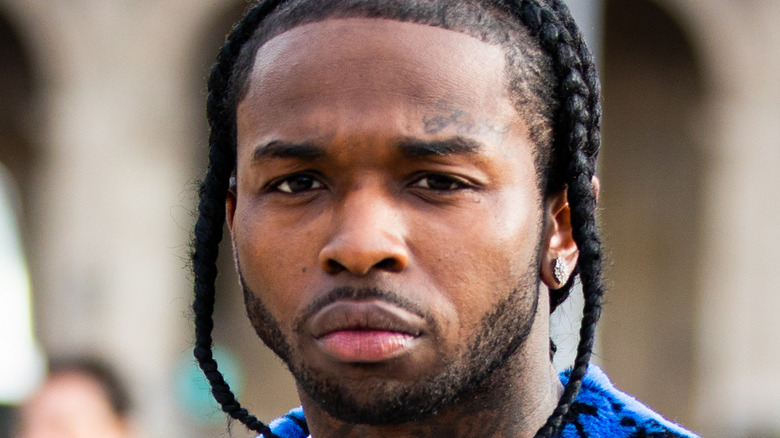 Rapper Pop Smoke, wearing a blue Off-White coat, is seen outside the Off-White show during the Paris Fashion Week - Menswear F/W 2020-2021