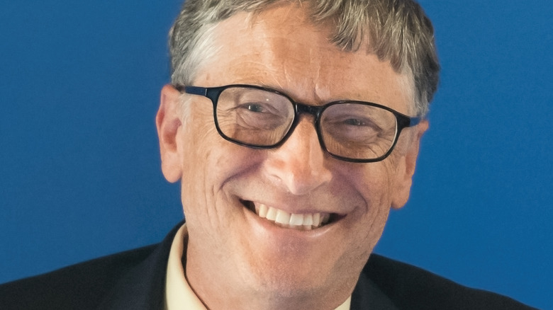 Bill Gates smiling wearing glasses