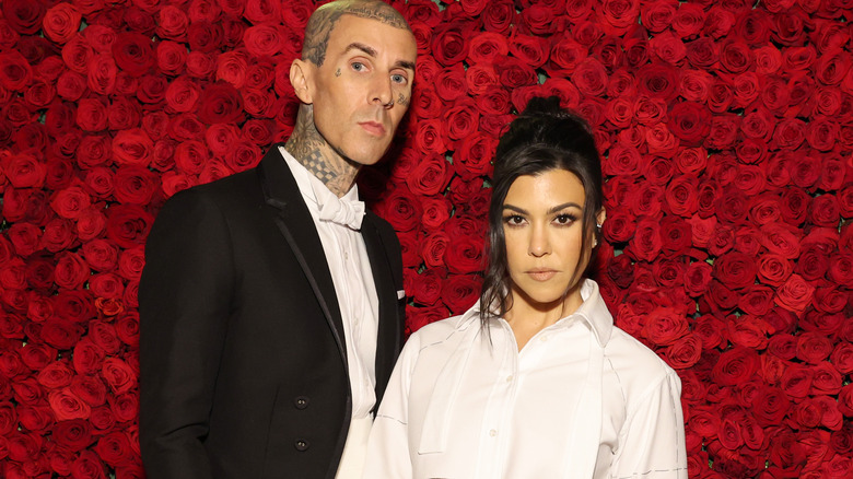 Travis Barker and Kourtney Kardashian posing