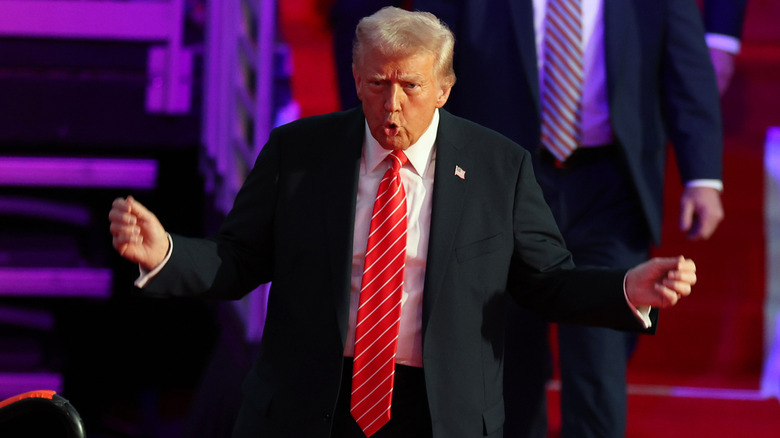 Donald Trump appears animated as he walks onto the stage at a victory rally.