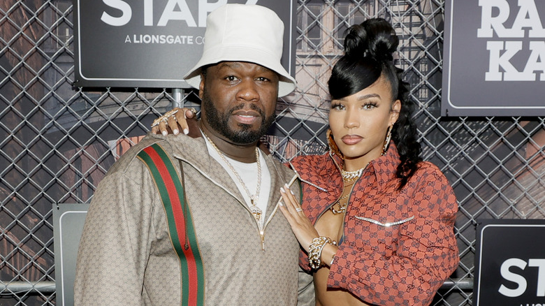 50 Cent and Jamira Haines dressed in '80s clothes