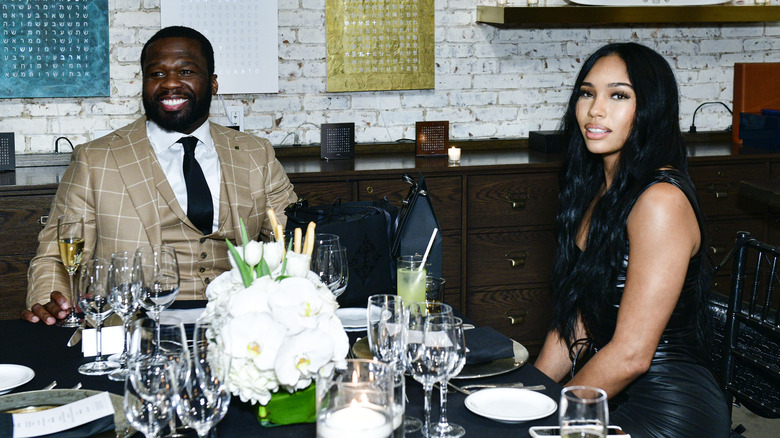 50 Cent and Jamira Haines sitting at a table