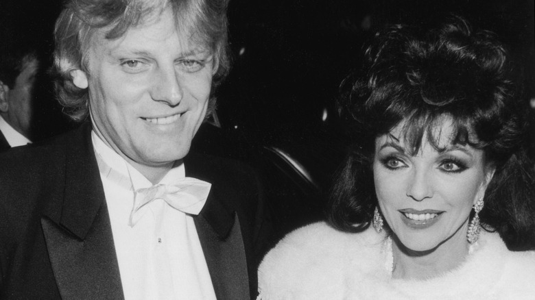 Joan Collins and Peter Holm smile