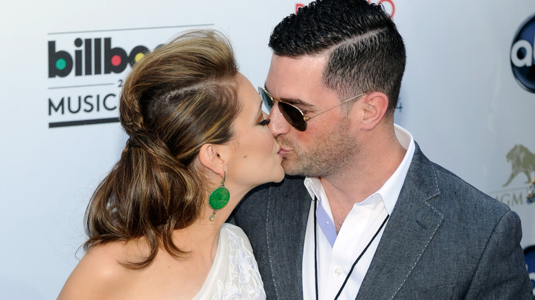 Alyssa Milano and her husband David Bugliari kissing at the Billboard music awards