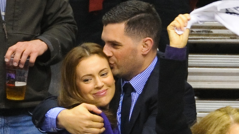 David Bugliari kissing his wife Alyssa Milano at a game